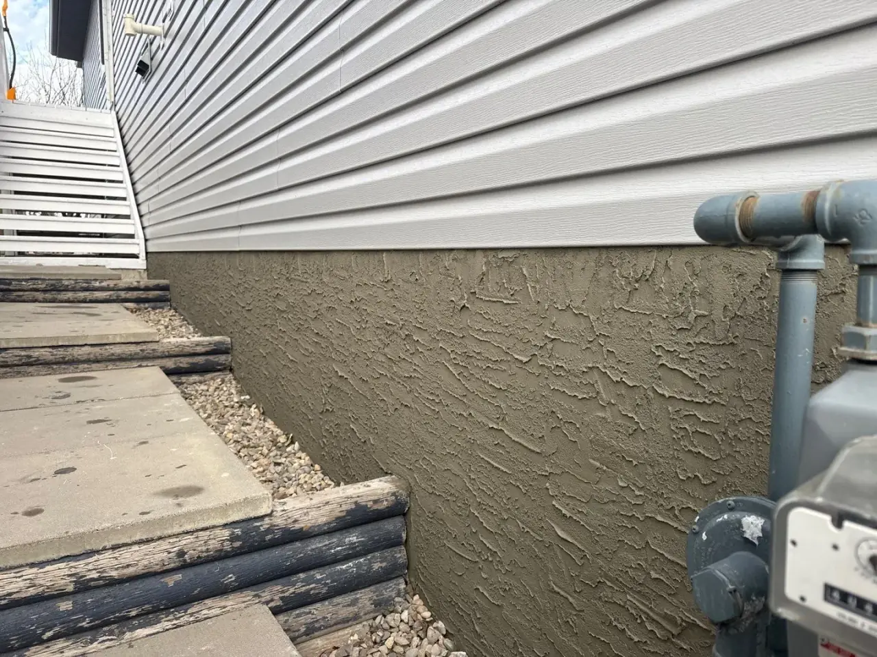 New textured parging after adhesive bonder application by Calgary Parging