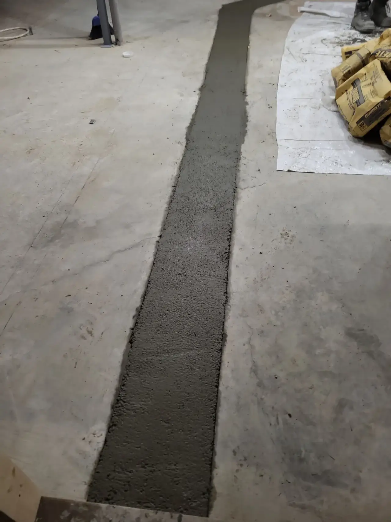 Foundation slab patched and sealed after repair