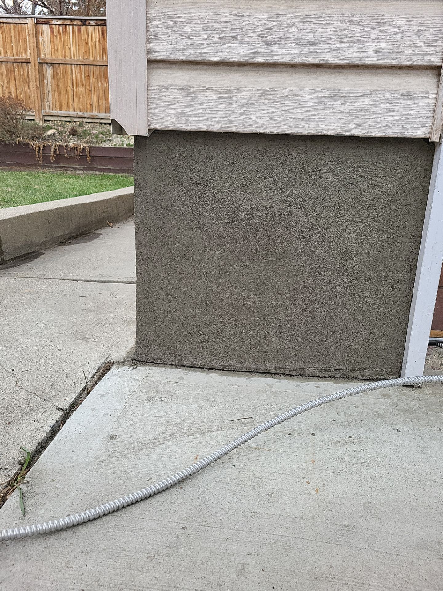 Garage foundation with new floated parging finish