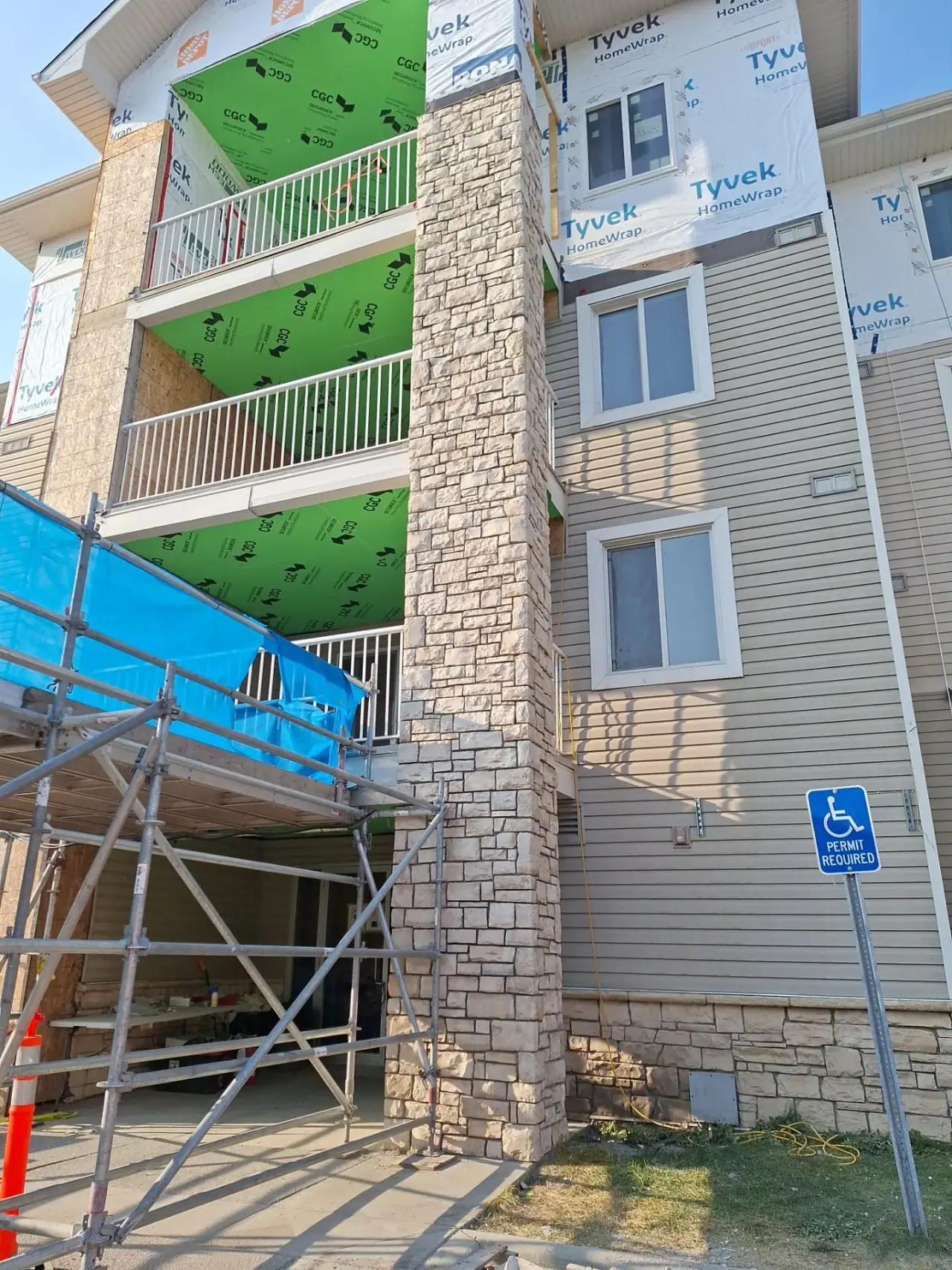 Three-story column finished with natural stone cladding