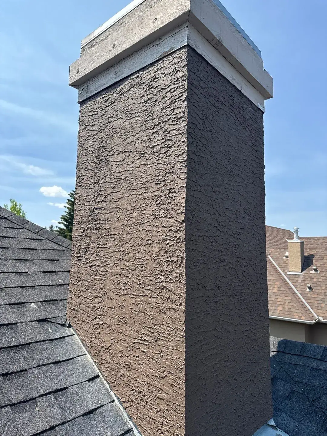 Chimney after new stucco repair and painting in Calgary