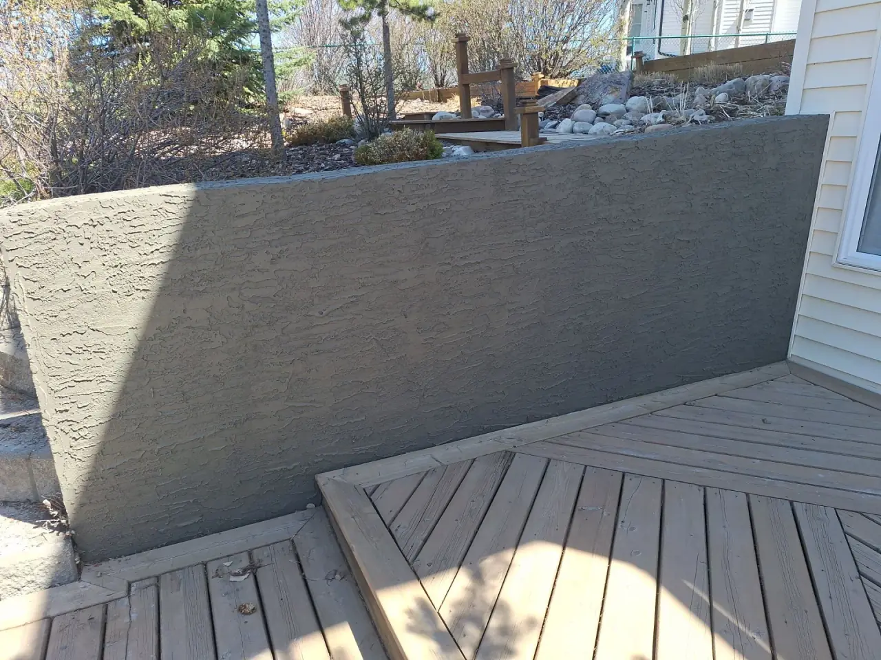 New textured parging on the same retaining wall