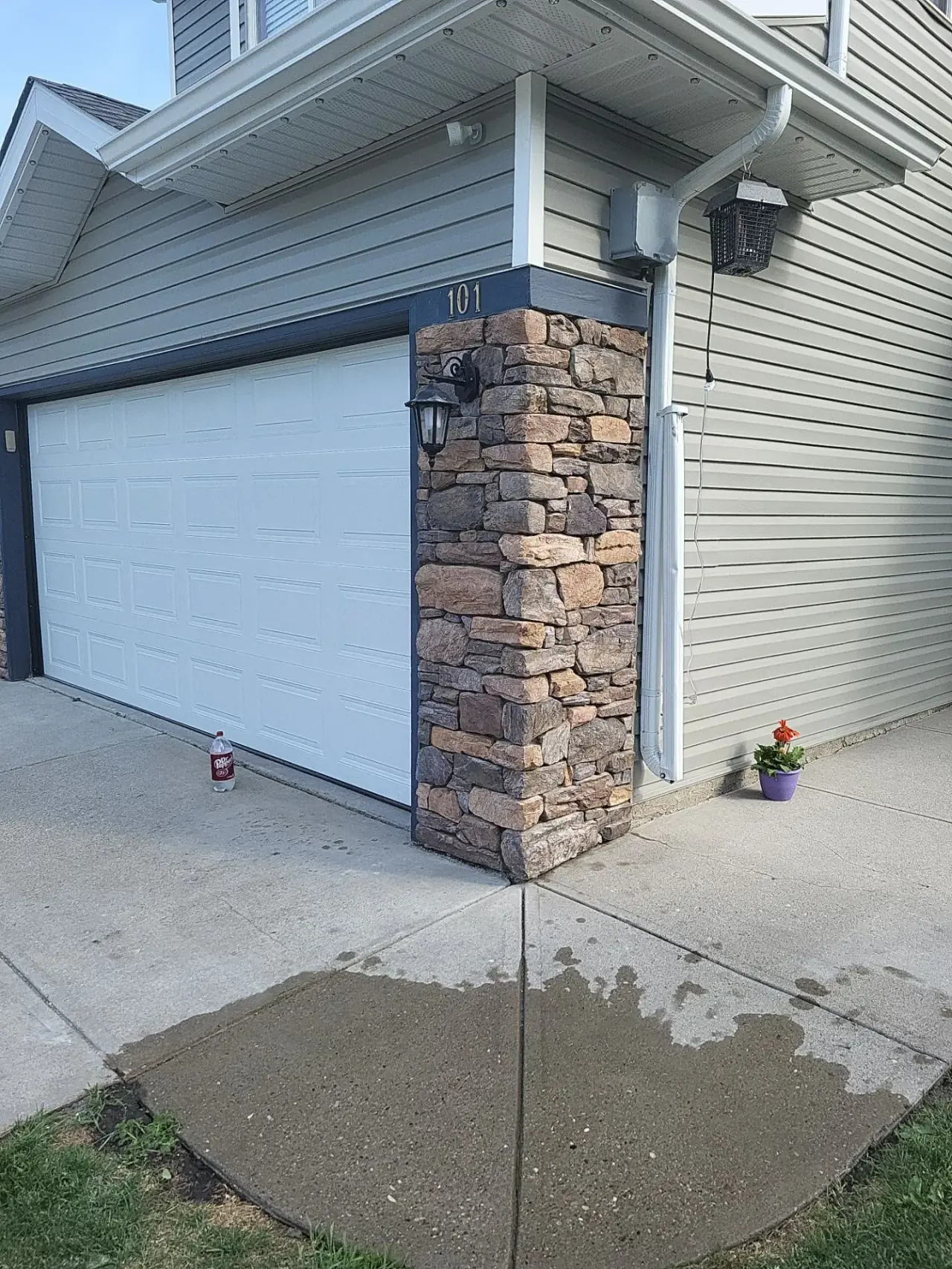 Rebuilt stone veneer pillar at entrance after repair