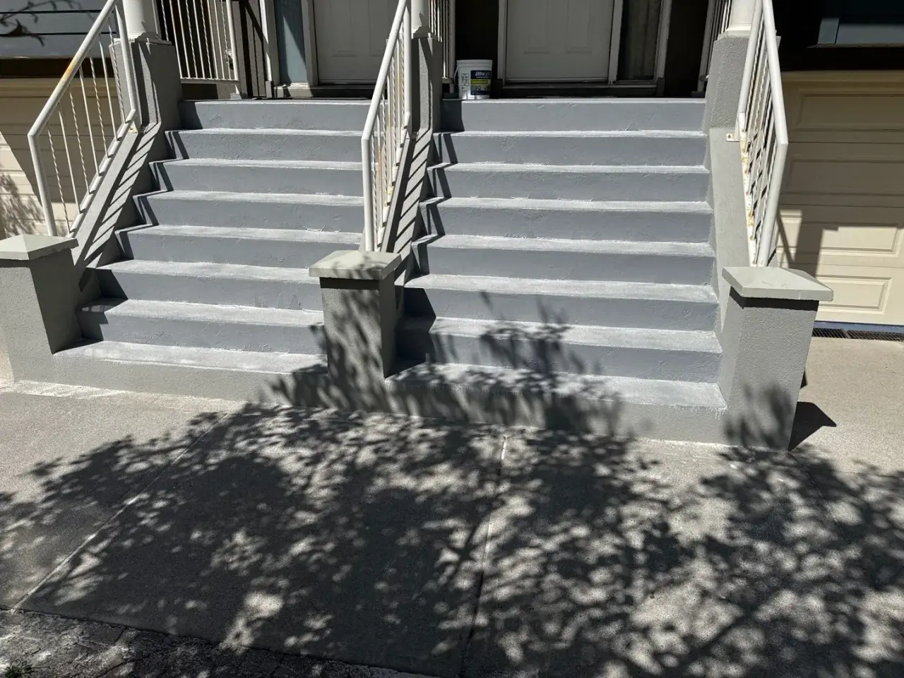 Refinished stucco columns, walkway and stairs after Calgary Parging repair