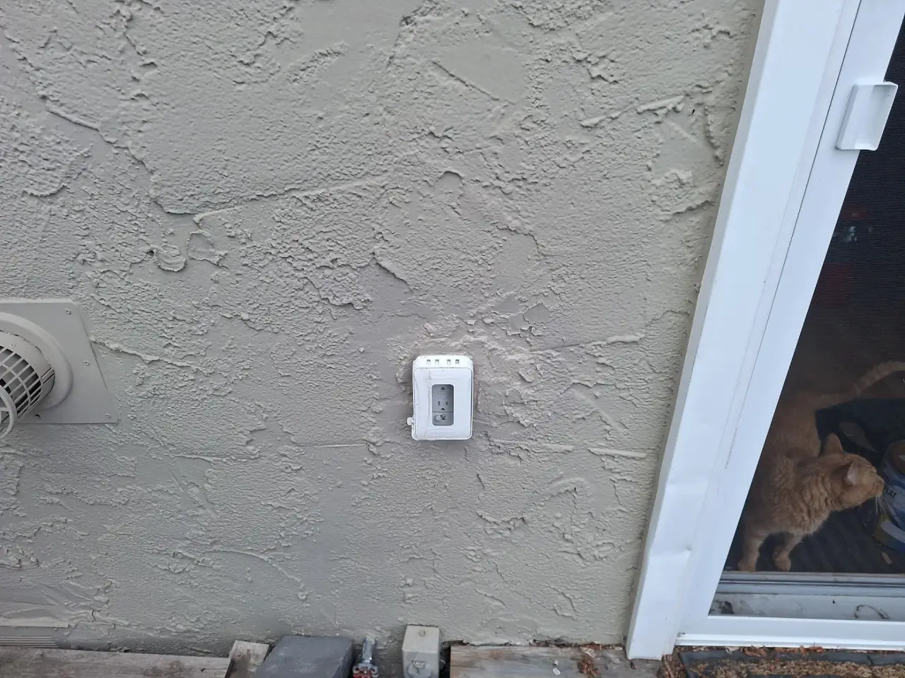 Stucco around outdoor outlet repaired and finish-matched