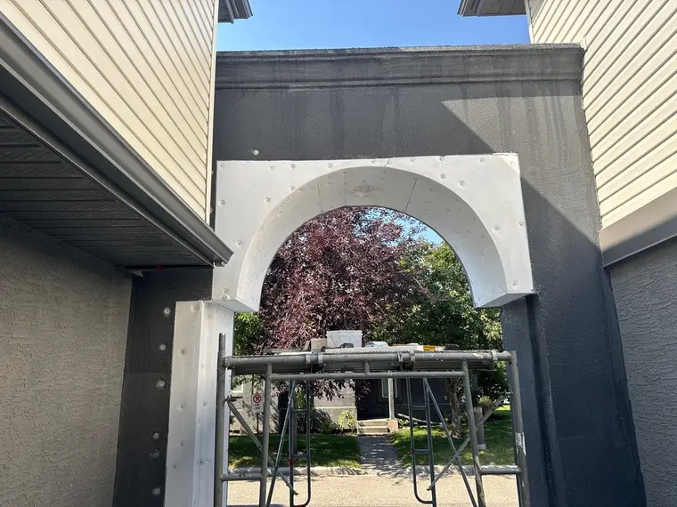 EIFS system rebuilt on the portico with custom cut styrofoam shaping the arch