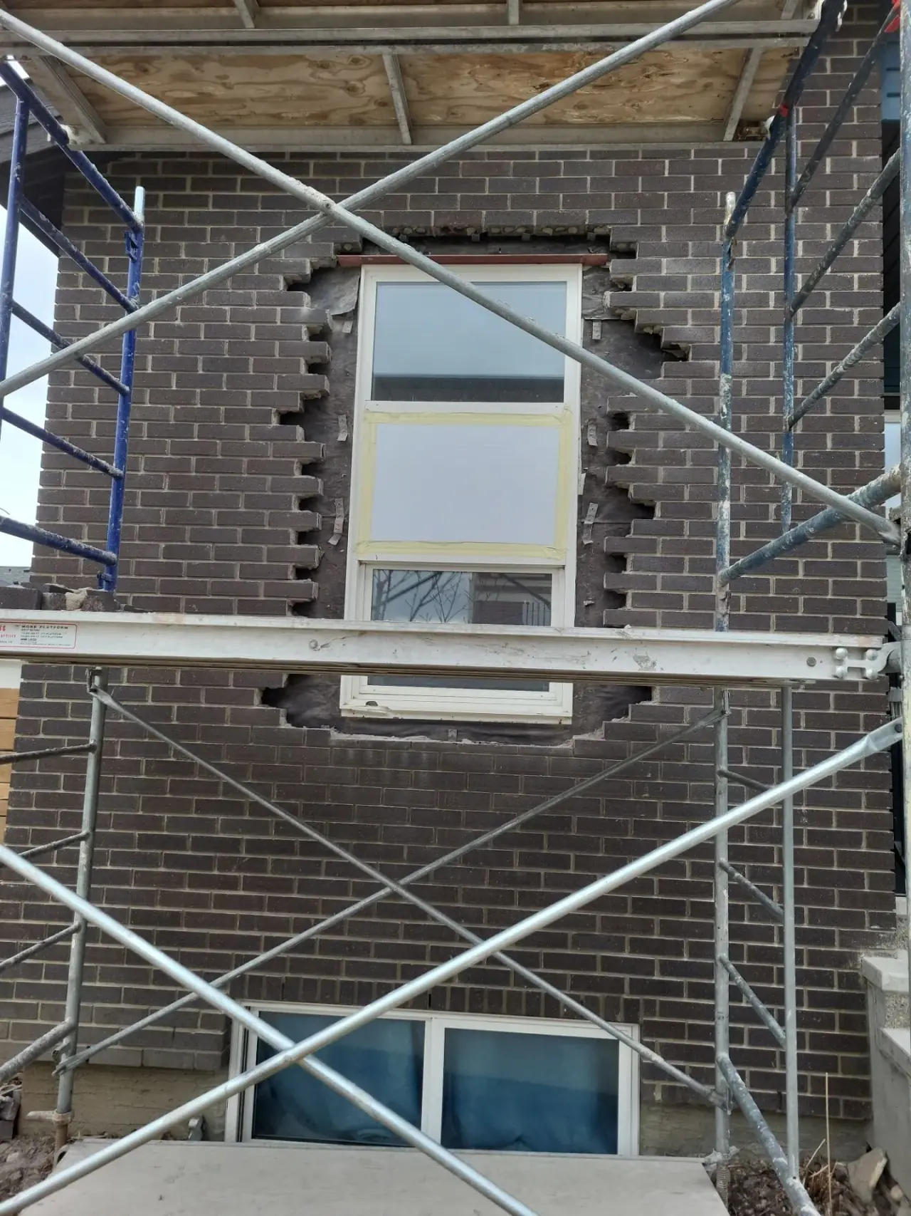Commercial brickwork around window before repair