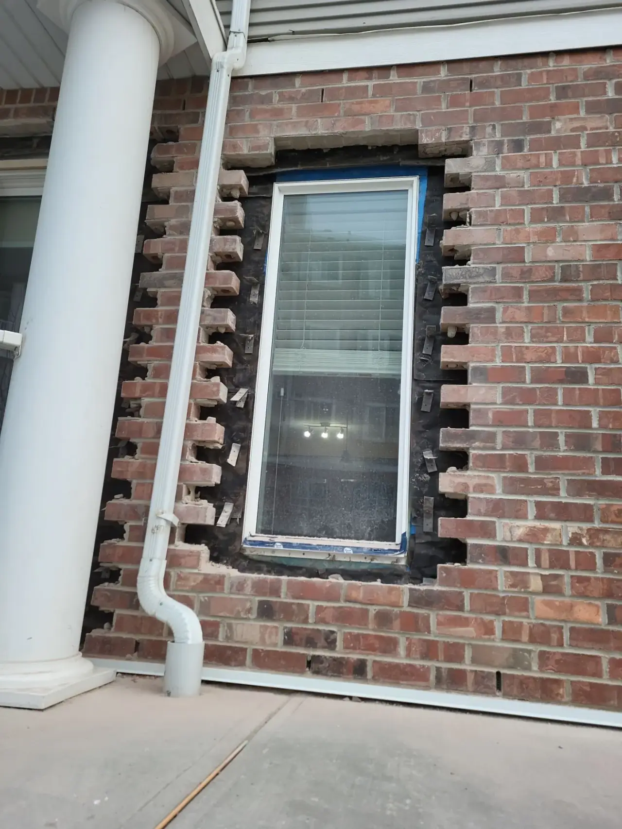 Residential brickwork around window before repair