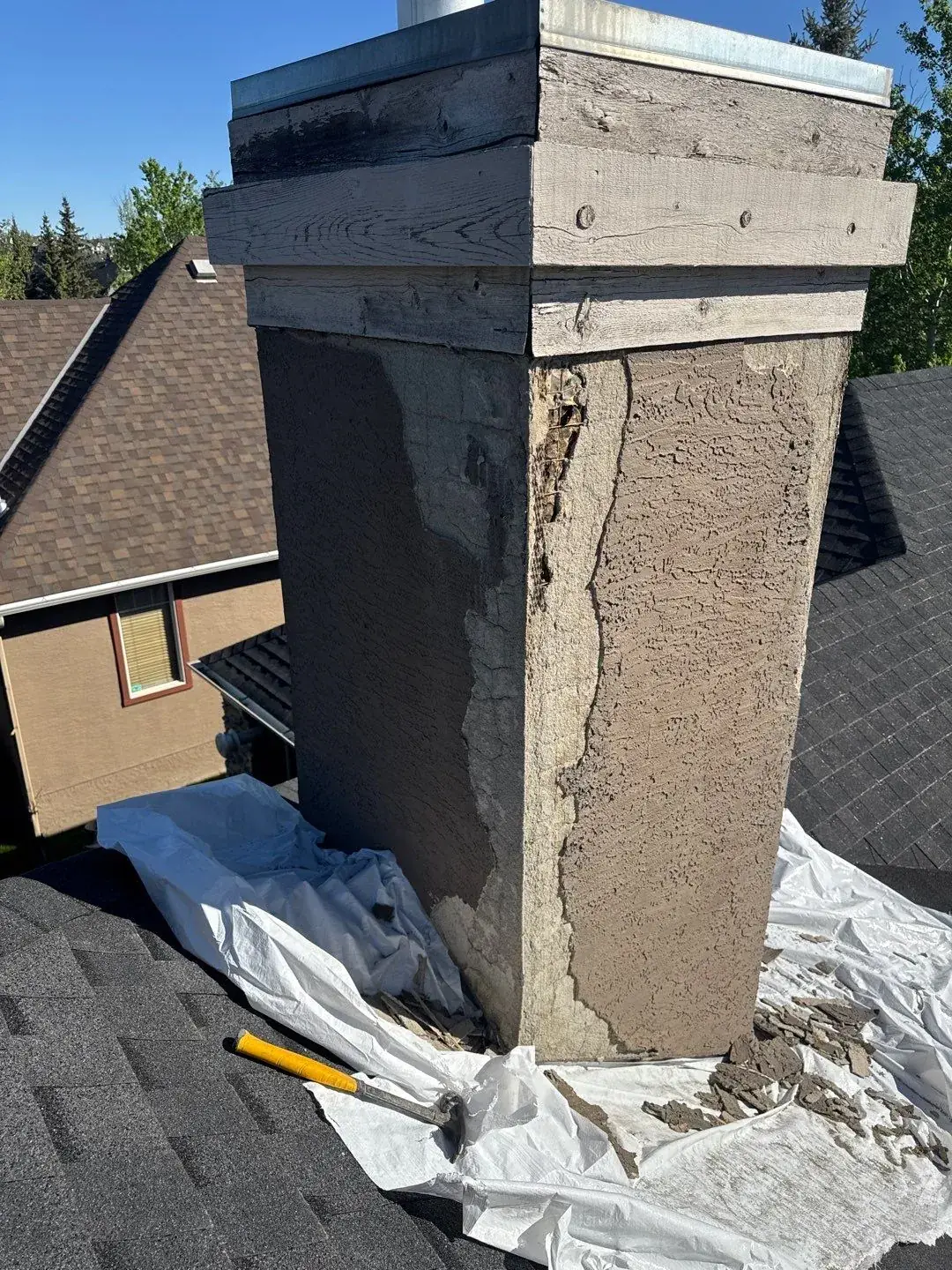 Deteriorated stucco chimney before repair