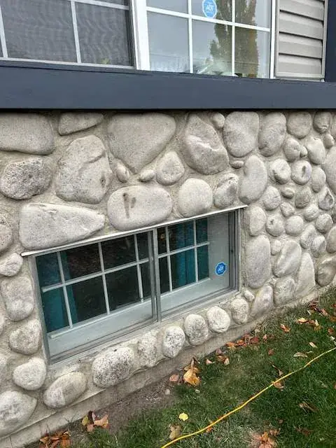 Damaged foundation stone veneer before replacement