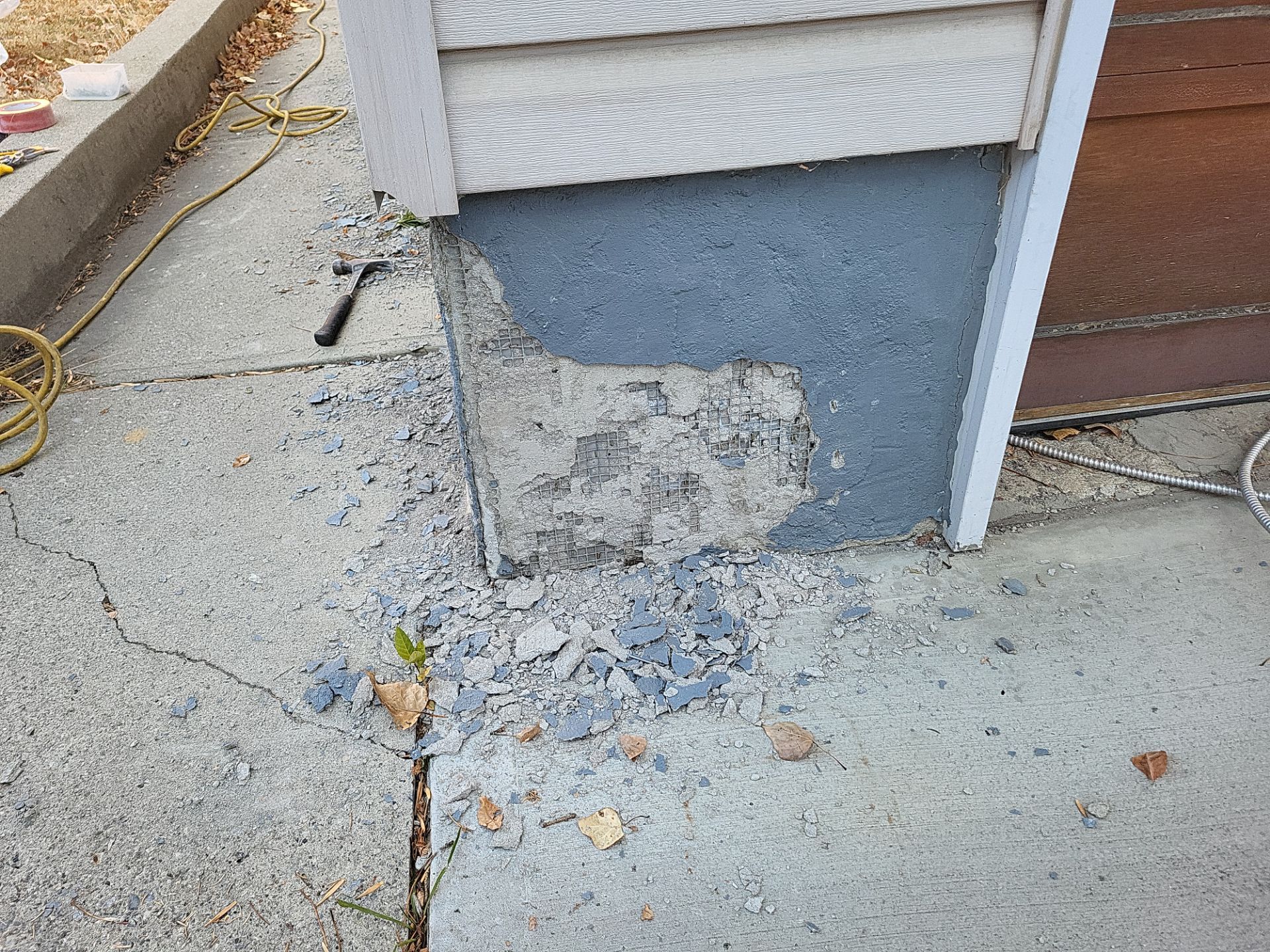 Deteriorated parging on a Calgary garage foundation