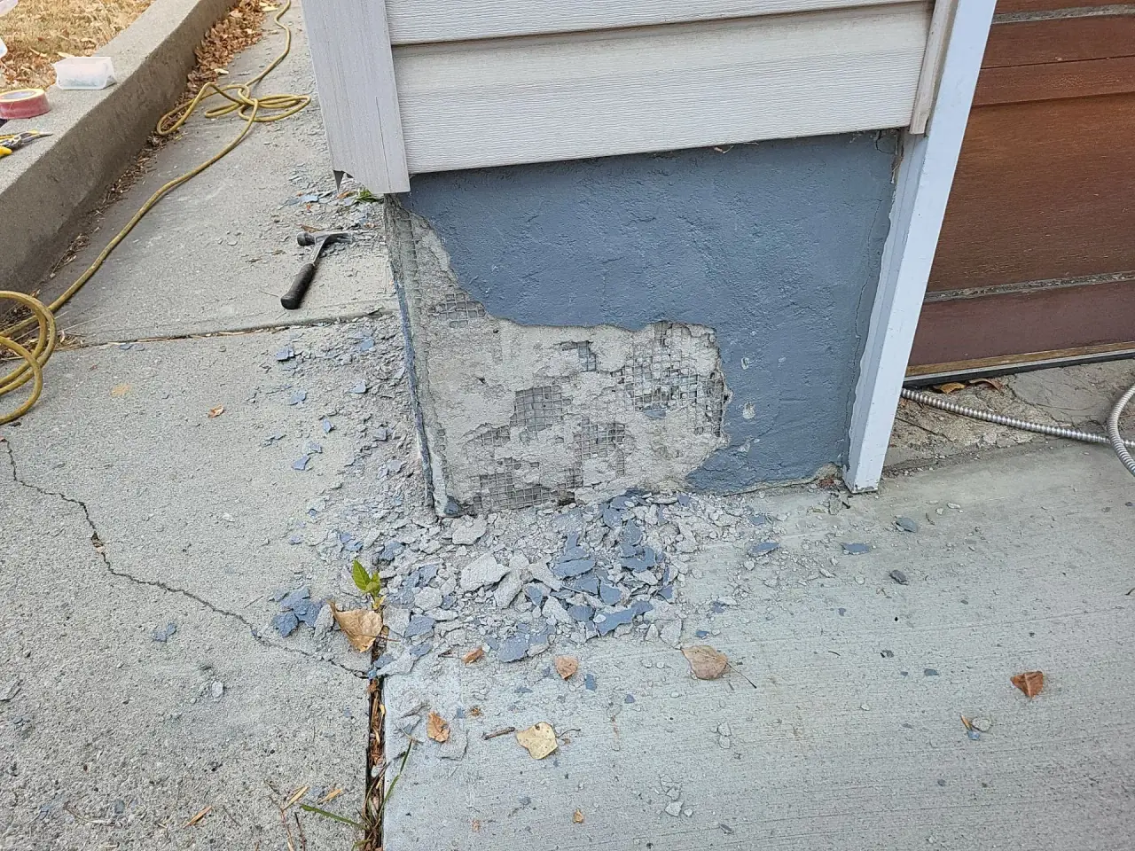 Deteriorated parging on a Calgary garage foundation