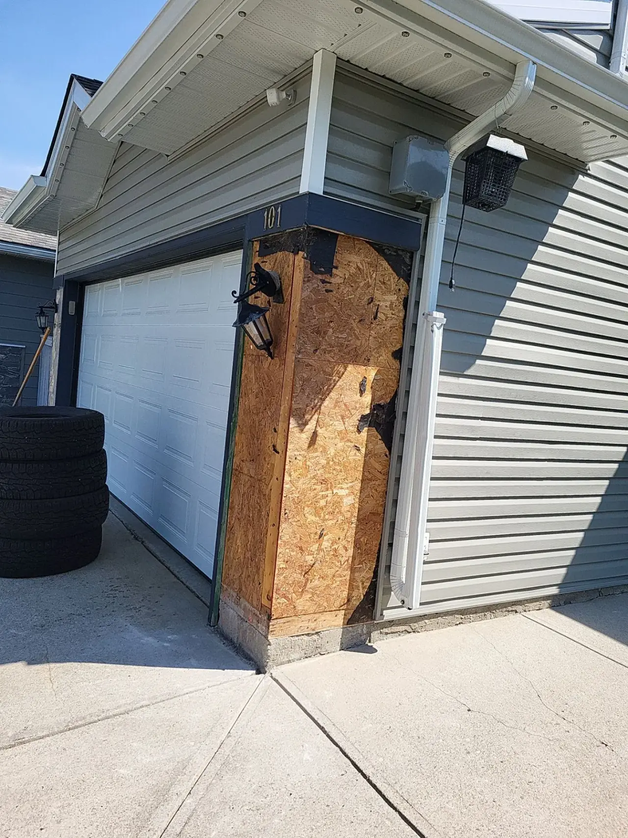Damaged stone veneer pillar at entrance before repair