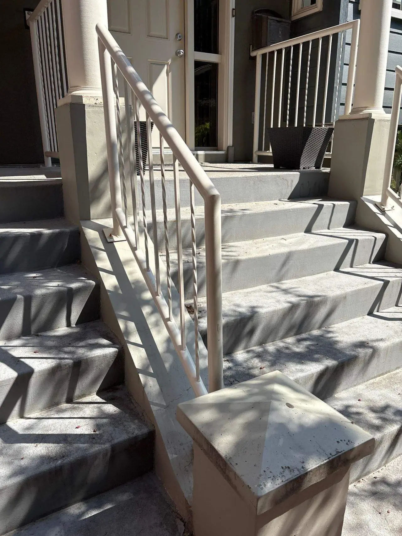 Aged stucco on columns, walkway and stairs before repair
