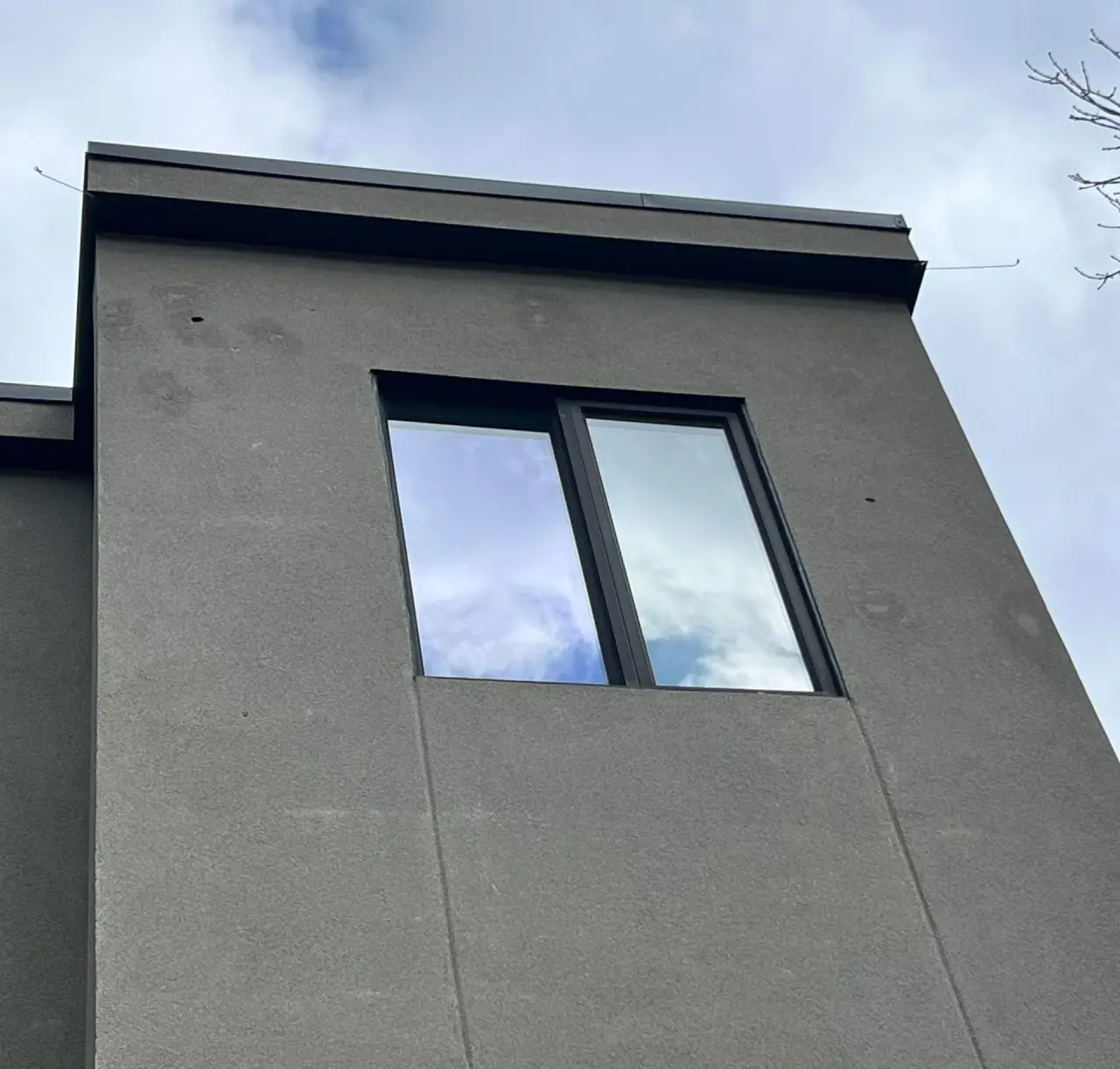 Floated stucco with woodpecker damage before repair