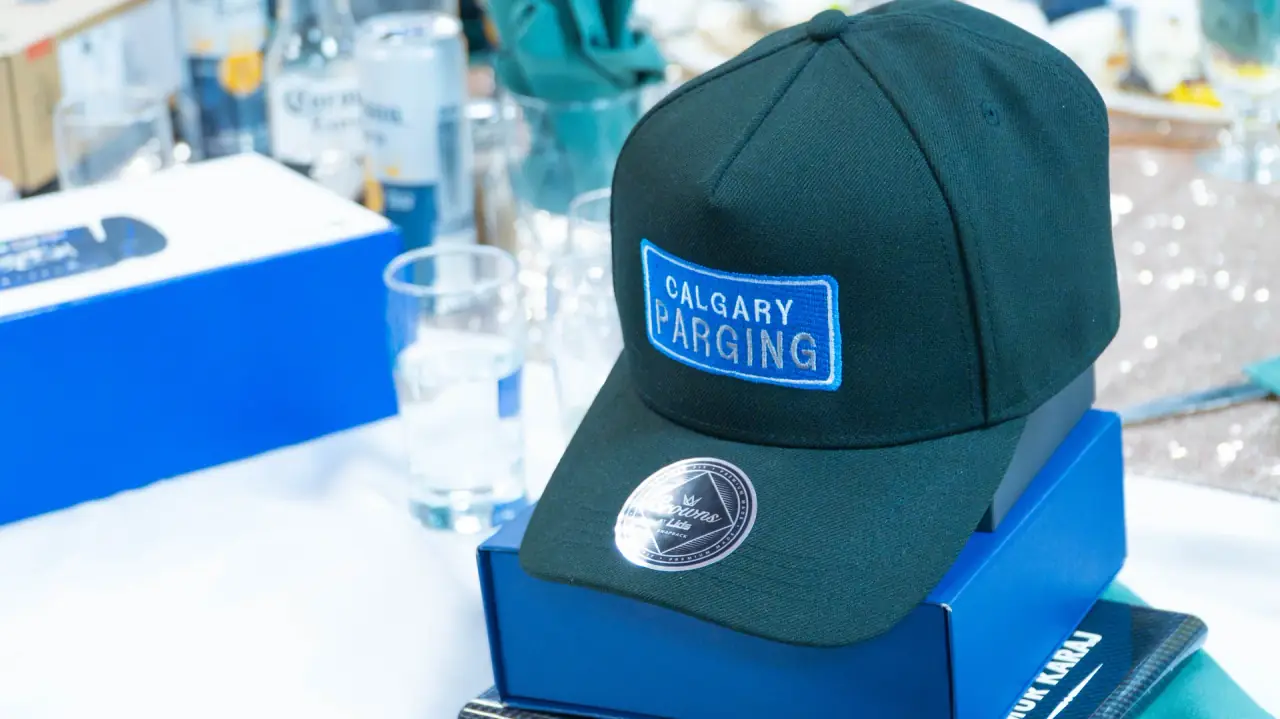 A Calgary Parging branded hat worn by a crew member