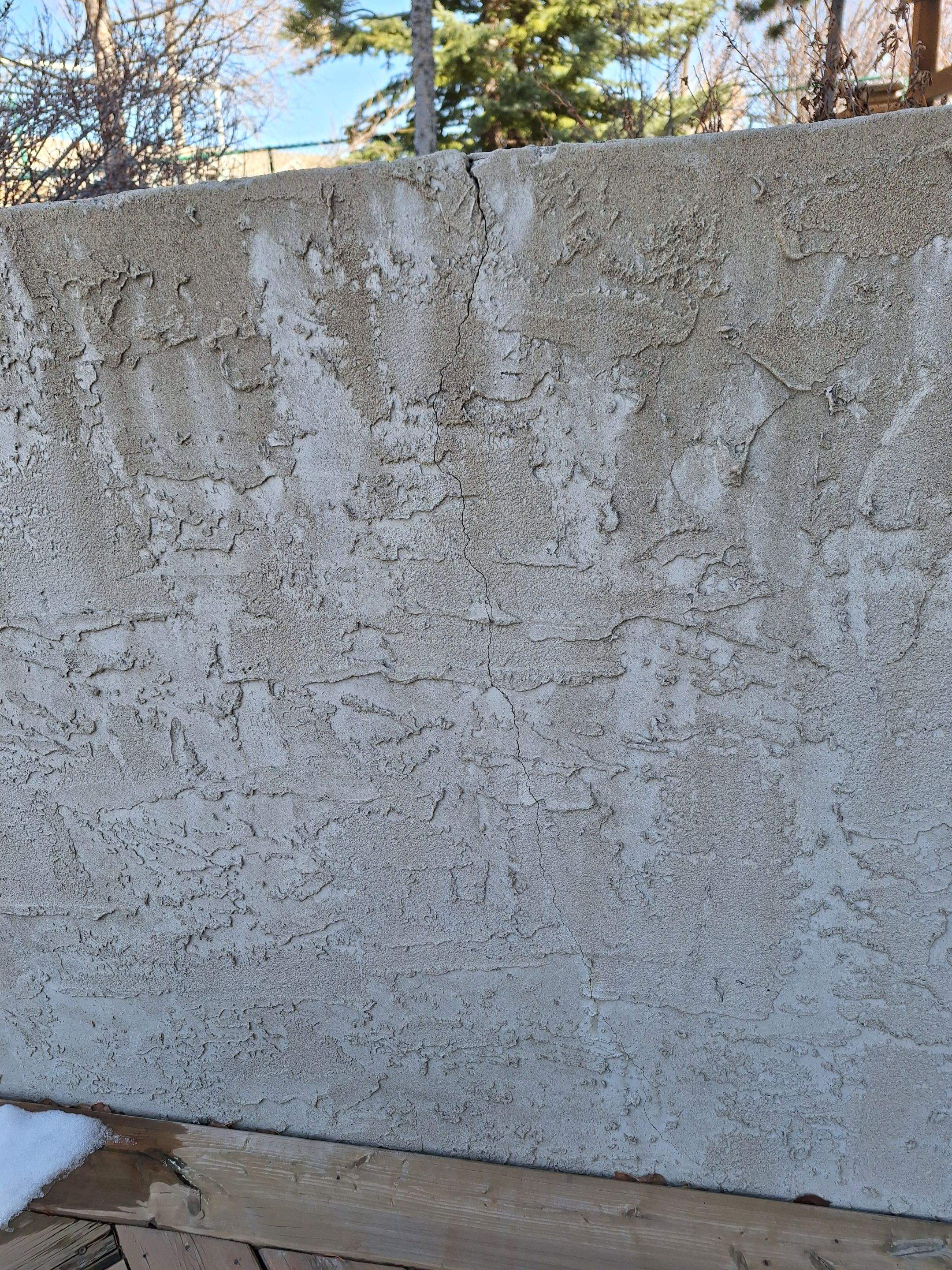 Deteriorated parging on a retaining wall