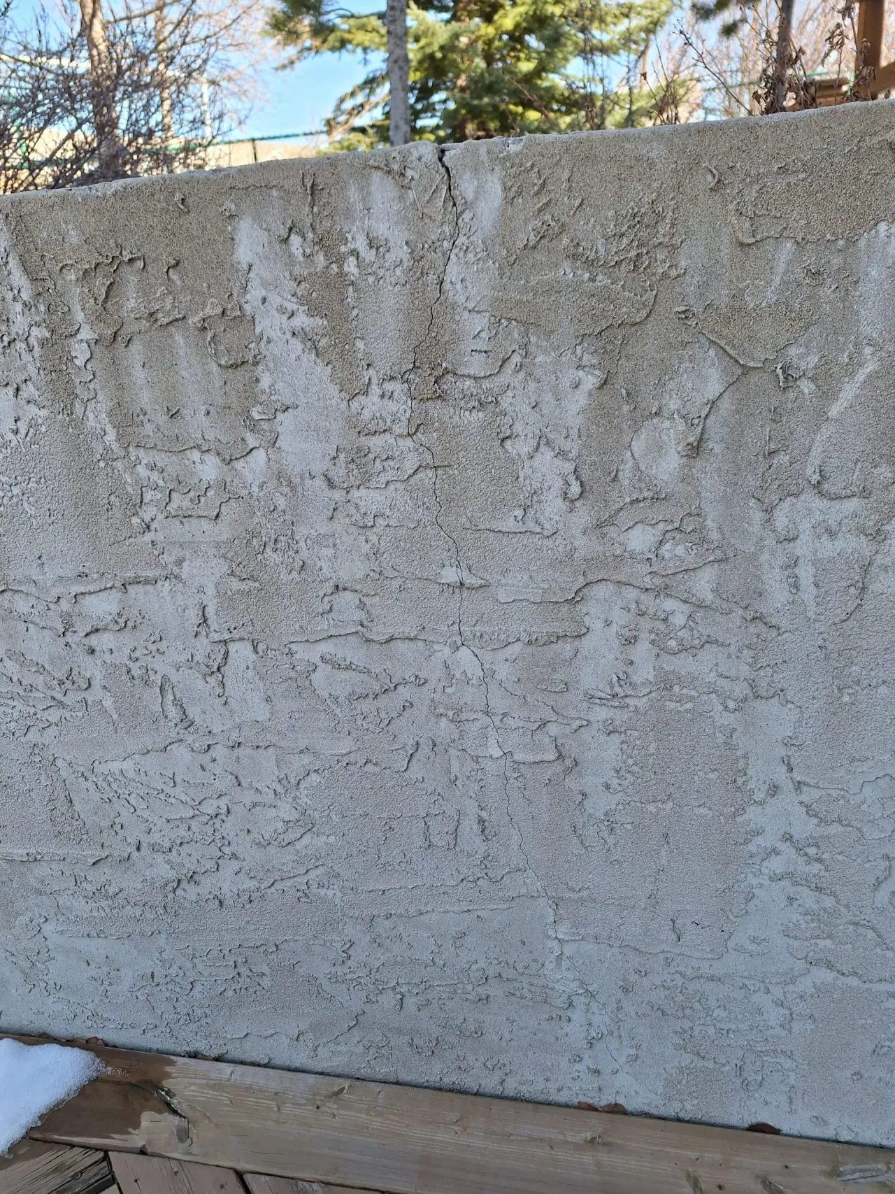 Deteriorated parging on a retaining wall