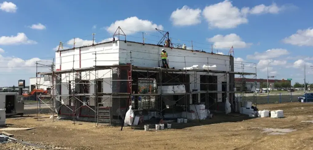 Eco-friendly EIFS stucco wall assembly with insulation layer
