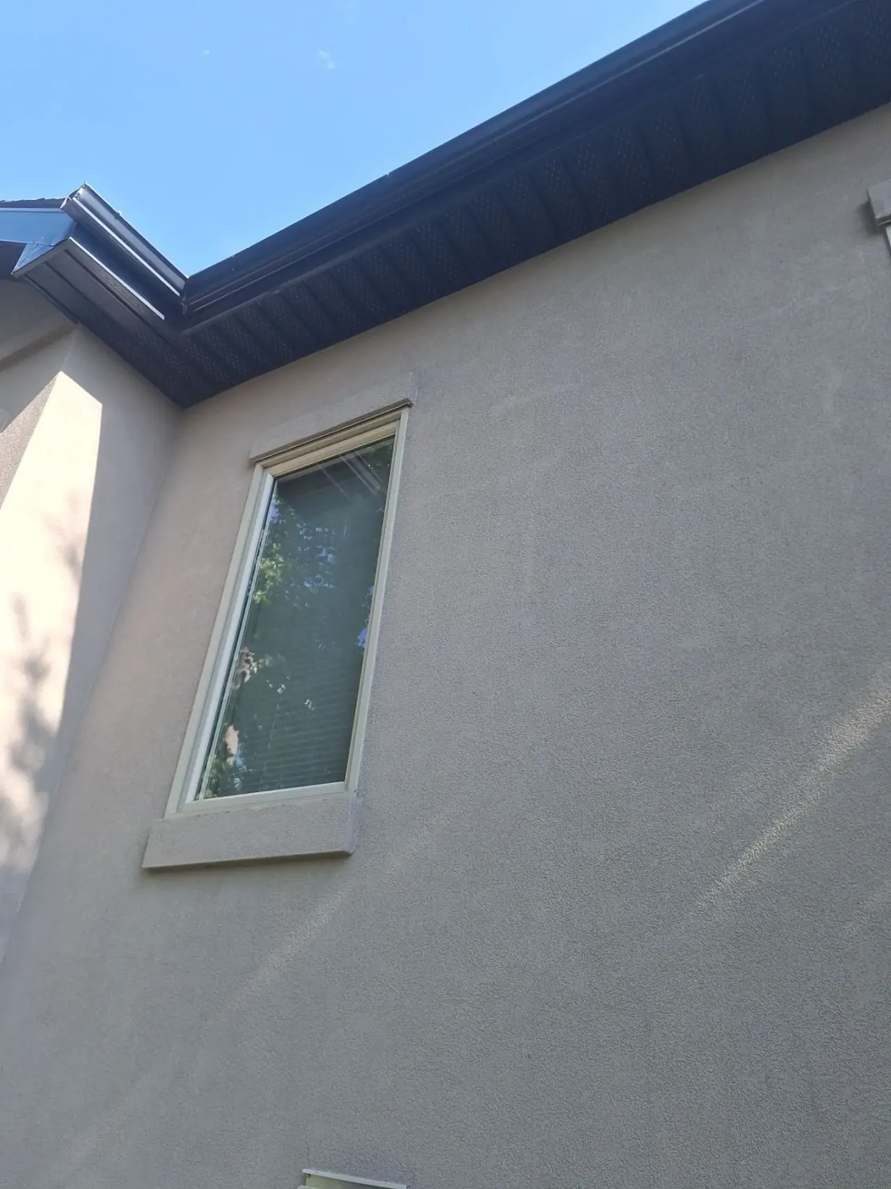New EIFS stucco at the top of the window batten after repair