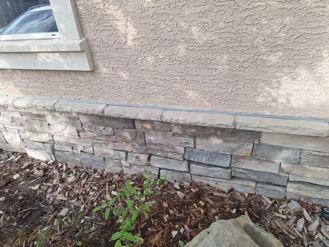 Natural stone foundation rebuilt with seamless matching stonework