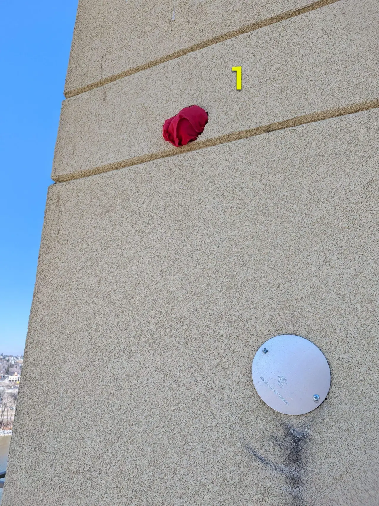 Condo units with woodpecker damage to stucco before repair
