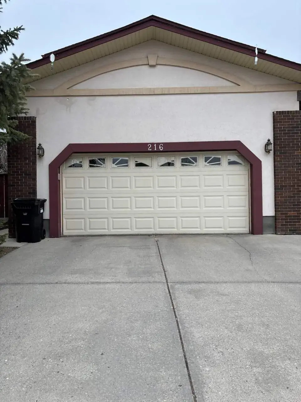 Garage stucco with woodpecker damage before repair